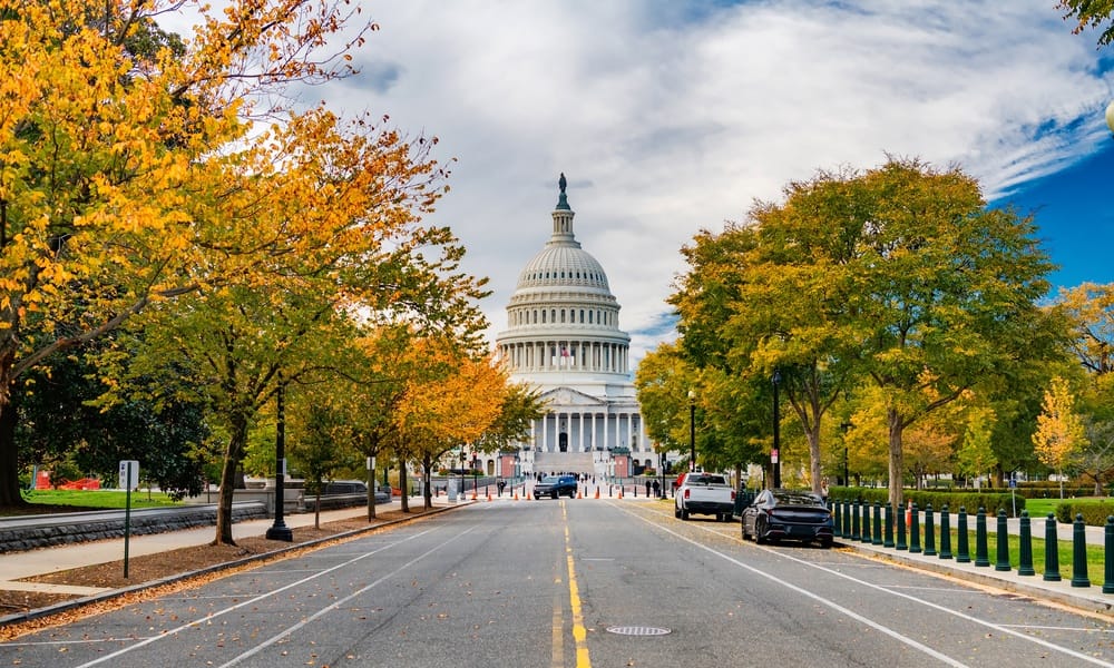 Symmetrical avenue view toward Capitol building in Washington DC during fall season daytime