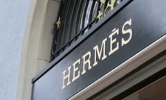 Logo sign of Hermes on a wall of an old building located in downtown Bern, Switzerland, March 2020. The logo is lit up. Hermes is a brand that offers luxury goods and is famous of designer handbags.
