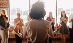 African american female empowering other colleagues in workplace