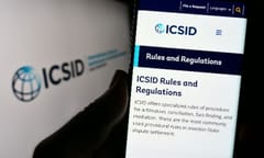 Stuttgart, Germany - 08-05-2023: Person holding smartphone with webpage of World Bank's institution ICSID on screen in front of logo. Focus on center of phone display. Unmodified photo.