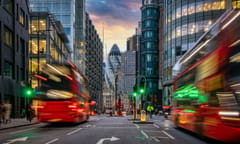 Sunset at the City of London, England, with traffic light trails and illuminated skyscrapers