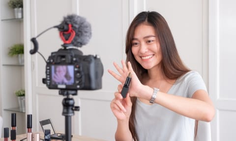 Asian young female blogger recording vlog video with makeup cosmetic at home online influencer on social media concept.live streaming viral